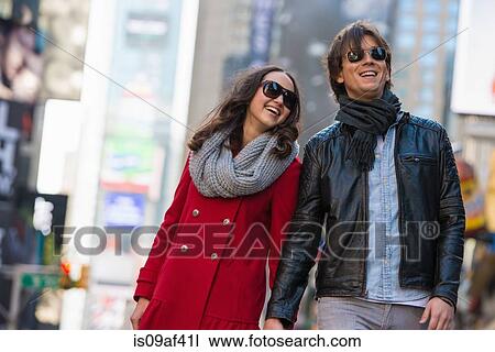 Stock Image - Young tourist couple holding hands, New York City, USA. Fotosearch