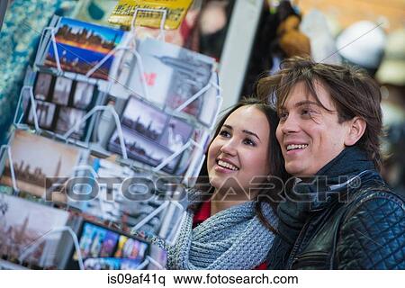 Young tourist couple looking at postcards, New York City, USA View Large Photo Image Stock Photography - Young tourist couple looking at postcards, New York City, USA. Fotosearch