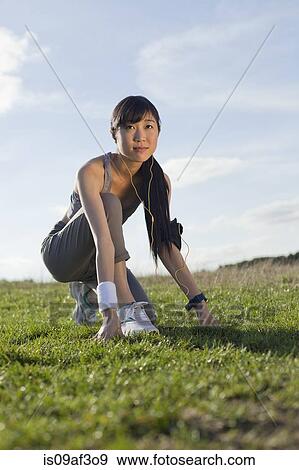 Stock Photo - Young woman preparing for run. Fotosearch