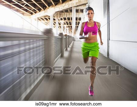 Blurred shot of young woman running on urban bridge View Large Photo Image Stock Photography - Blurred shot of young woman running on urban bridge. Fotosearch