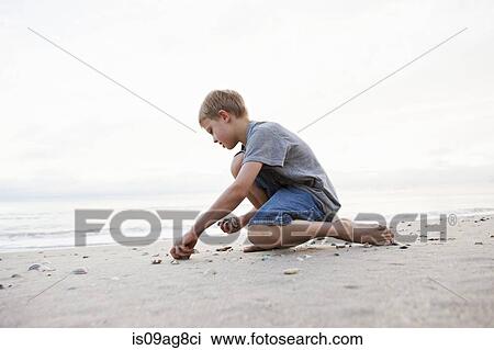 Boy playing on beach View Large Photo Image Stock Image - Boy playing on beach. Fotosearch