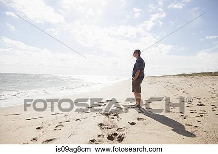 Man looking out to sea, Satellite Beach, Florida, US View Large Photo Image Picture - Man looking out to sea, Satellite Beach, Florida, US. Fotosearch