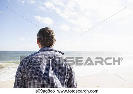 Man looking out to sea, Satellite Beach, Florida, US View Large Photo Image Picture - Man looking out to sea, Satellite Beach, Florida, US. Fotosearch