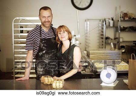 Portrait of baker couple behind kitchen counter View Large Photo Image Stock Image - Portrait of baker couple behind kitchen counter. Fotosearch