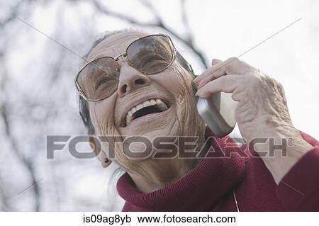 Stock Image - Portrait of senior woman on the phone. Fotosearch