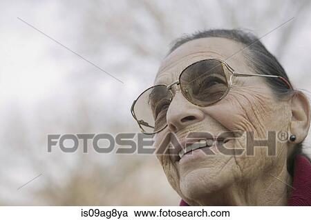 Stock Image - Portrait of senior woman wearing eyeglasses. Fotosearch
