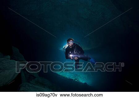 Stock Photo - Scuba diver enters Ben's Cave.. Fotosearch