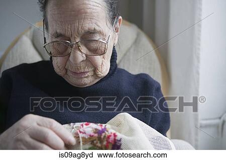 Senior woman doing cross stitch View Large Photo Image Stock Image - Senior woman doing cross stitch. Fotosearch