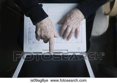 Senior woman pointing at laptop screen View Large Photo Image Stock Image - Senior woman pointing at laptop screen. Fotosearch