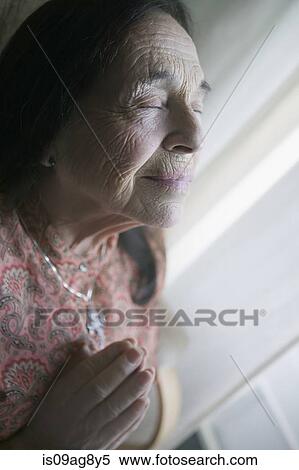 Senior woman praying View Large Photo Image Stock Photography - Senior woman praying. Fotosearch