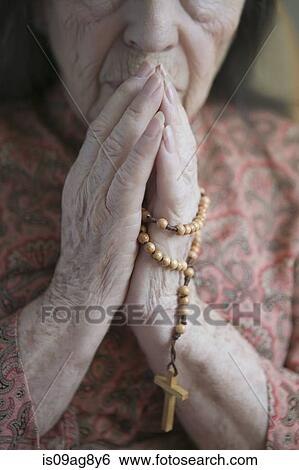 Senior woman praying with rosary View Large Photo Image Stock Photograph - Senior woman praying with rosary. Fotosearch