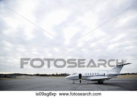 Stationary private jet on airport runway View Large Photo Image Stock Photography - Stationary private jet on airport runway. Fotosearch