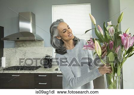Woman arranging lilies View Large Photo Image Stock Image - Woman arranging lilies. Fotosearch