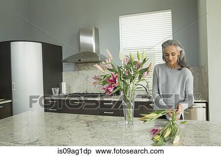 Woman arranging lilies View Large Photo Image Stock Photography - Woman arranging lilies. Fotosearch
