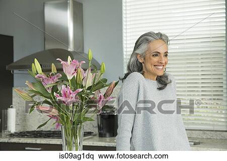 Woman by lily arrangement View Large Photo Image Stock Photography - Woman by lily arrangement. Fotosearch