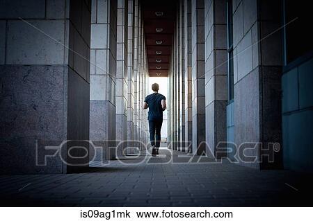 Young man running along urban sidewalk View Large Photo Image Stock Image - Young man running along urban sidewalk. Fotosearch