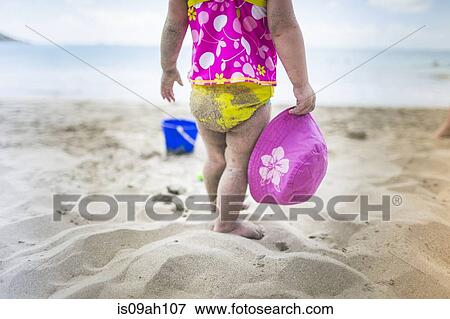 Baby playing on sandy beach View Large Photo Image Stock Photo - Baby playing on sandy beach. Fotosearch
