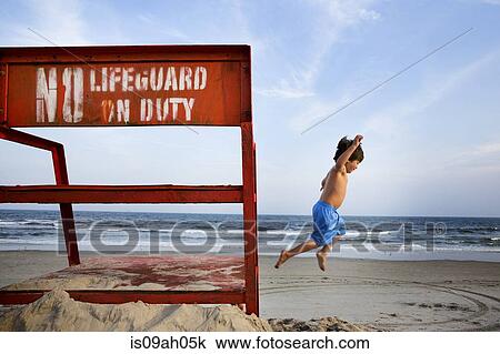 Boys jumping mid air, Long Beach, New York State, USA View Large Photo Image Stock Image - Boys jumping mid air, Long Beach, New York State, USA. Fotosearch