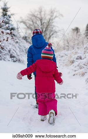 Brother and sister walking in snow View Large Photo Image Stock Photo - Brother and sister walking in snow. Fotosearch