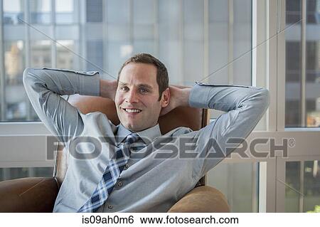 Businessman relaxing in office armchair View Large Photo Image Stock Photograph - Businessman relaxing in office armchair. Fotosearch