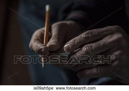 Close up of male hands holding a pencil and piece of wood View Large Photo Image Stock Image - Close up of male hands holding a pencil and piece of wood. Fotosearch
