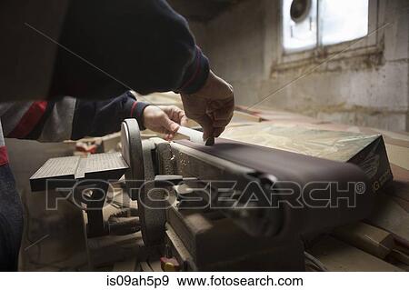 Close up of mature man using sanding belt in workshop View Large Photo Image Stock Photo - Close up of mature man using sanding belt in workshop. Fotosearch