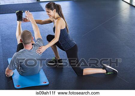 Couple helping each other in gym View Large Photo Image Stock Image - Couple helping each other in gym. Fotosearch
