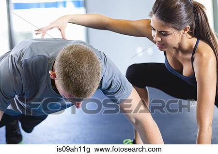 Couple helping each other in gym View Large Photo Image Stock Image - Couple helping each other in gym. Fotosearch
