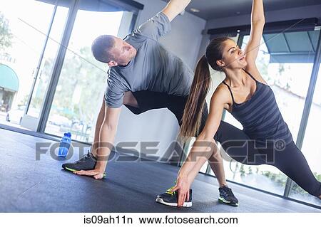 Couple in triangle pose View Large Photo Image Picture - Couple in triangle pose. Fotosearch