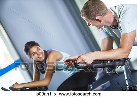 Couple on cycling machine View Large Photo Image Stock Photo - Couple on cycling machine. Fotosearch