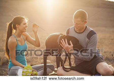 Stock Image - Couple with dog. Fotosearch