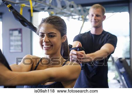 Couple working out in gym View Large Photo Image Stock Photo - Couple working out in gym. Fotosearch