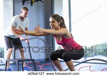 Couple working out in gym View Large Photo Image Stock Photo - Couple working out in gym. Fotosearch