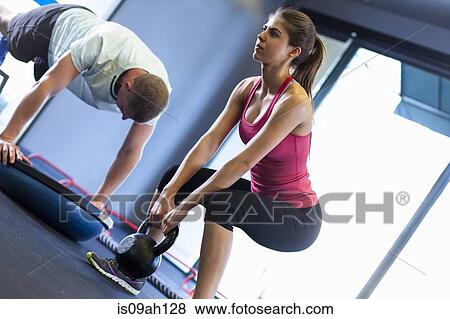 Couple working out in gym View Large Photo Image Stock Photo - Couple working out in gym. Fotosearch