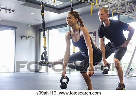 Couple working out with weights View Large Photo Image Stock Photo - Couple working out with weights. Fotosearch