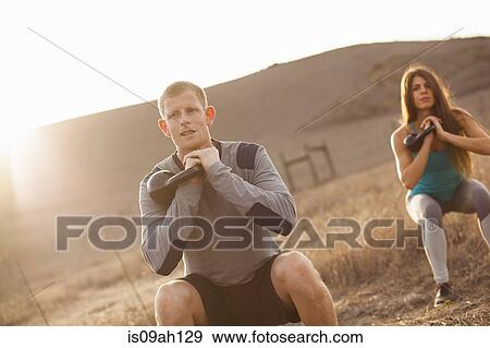 Couple working out with weights View Large Photo Image Stock Photo - Couple working out with weights. Fotosearch