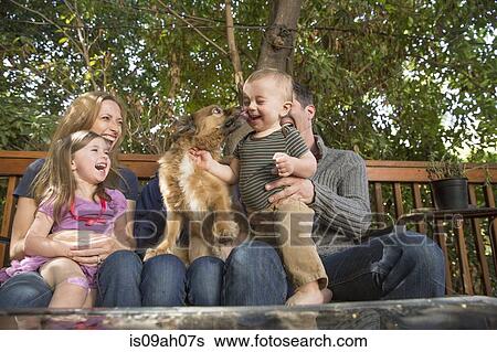 Family relaxing on porch View Large Photo Image Stock Photograph - Family relaxing on porch. Fotosearch