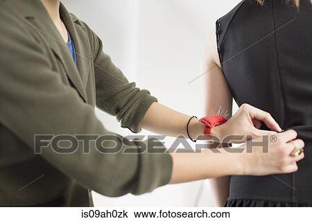 Stock Image - Fashion designer pinning top. Fotosearch