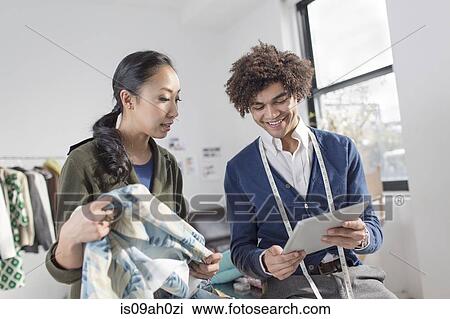 Fashion designers using digital tablet View Large Photo Image Stock Image - Fashion designers using digital tablet. Fotosearch