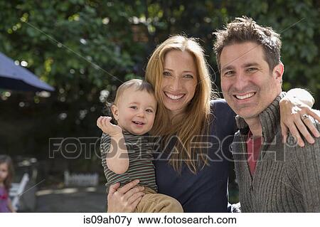 Father and mother with baby in garden View Large Photo Image Stock Photo - Father and mother with baby in garden. Fotosearch