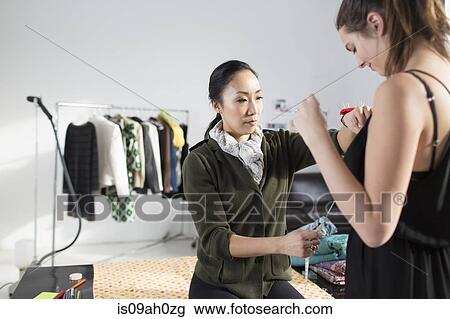 Female fashion designer using tape measure View Large Photo Image Stock Image - Female fashion designer using tape measure. Fotosearch