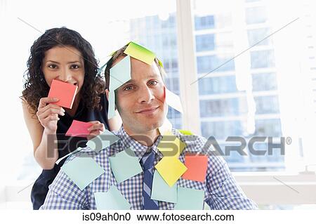 Female office worker covering male colleague with sticky notes View Large Photo Image Stock Image - Female office worker covering male colleague with sticky notes. Fotosearch