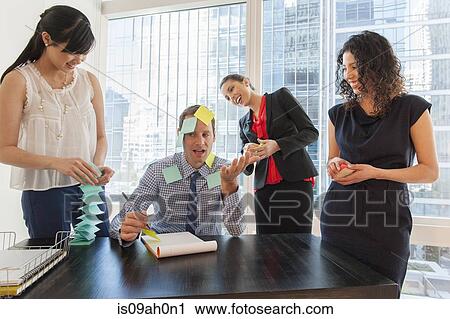 Female office workers covering male colleague with sticky notes View Large Photo Image Stock Image - Female office workers covering male colleague with sticky notes. Fotosearch