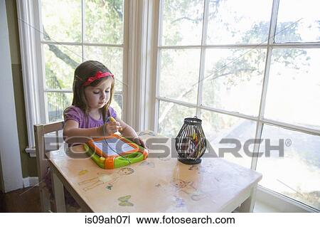 Girl drawing indoors View Large Photo Image Stock Image - Girl drawing indoors. Fotosearch