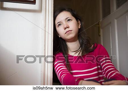 Stock Photo - Girl leaning against doorway. Fotosearch