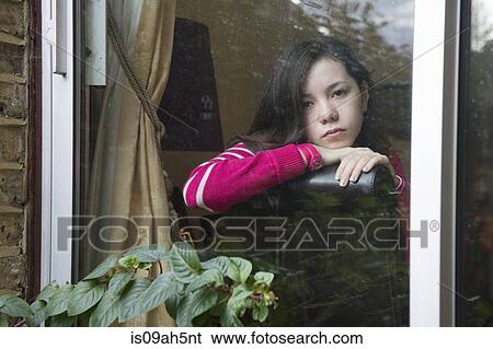 Girl looking through window View Large Photo Image Stock Photograph - Girl looking through window. Fotosearch
