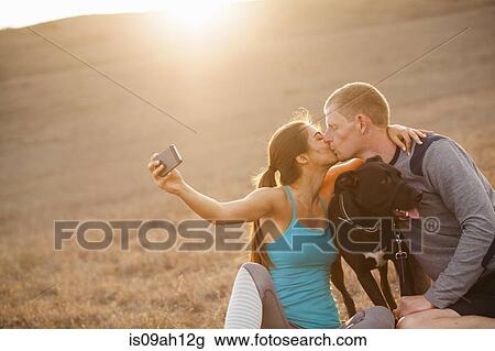 Kissing couple with dog View Large Photo Image Stock Image - Kissing couple with dog. Fotosearch