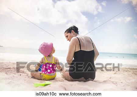 Stock Image - Mother and daughter by seaside. Fotosearch