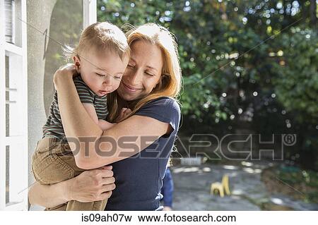 Stock Photo - Mother hugging baby. Fotosearch