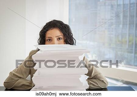 Portrait of businesswoman with a stack of paperwork View Large Photo Image Stock Image - Portrait of businesswoman with a stack of paperwork. Fotosearch